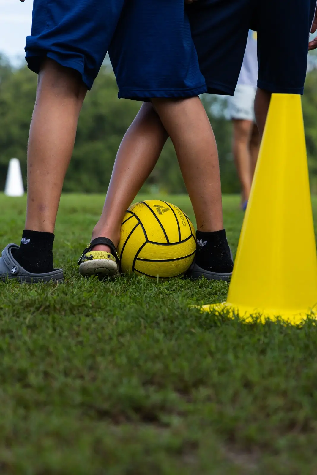 A ball and cone on the grass during a dryland session at camp