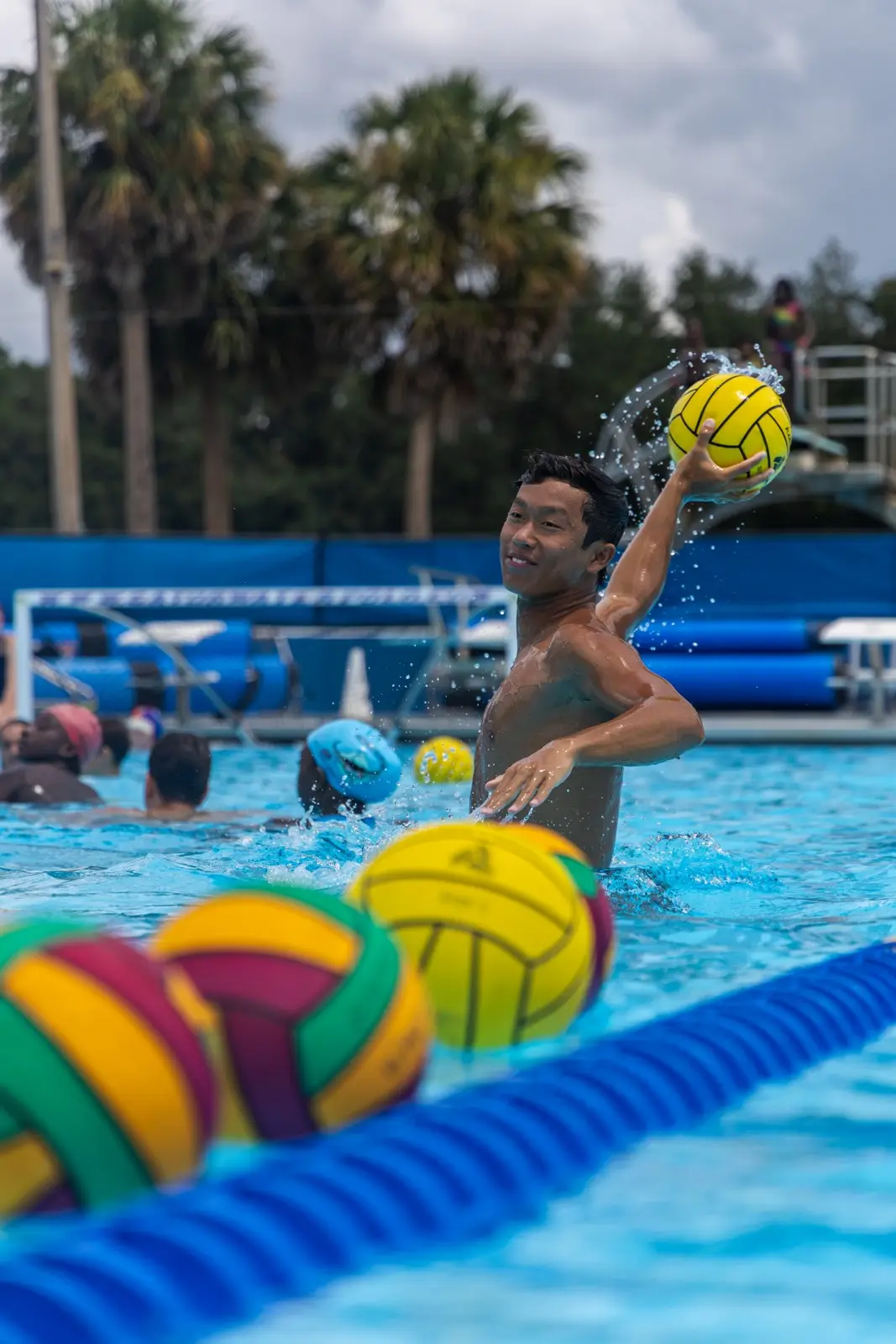 A camper firing a shot beyond a row of balls on the lane line