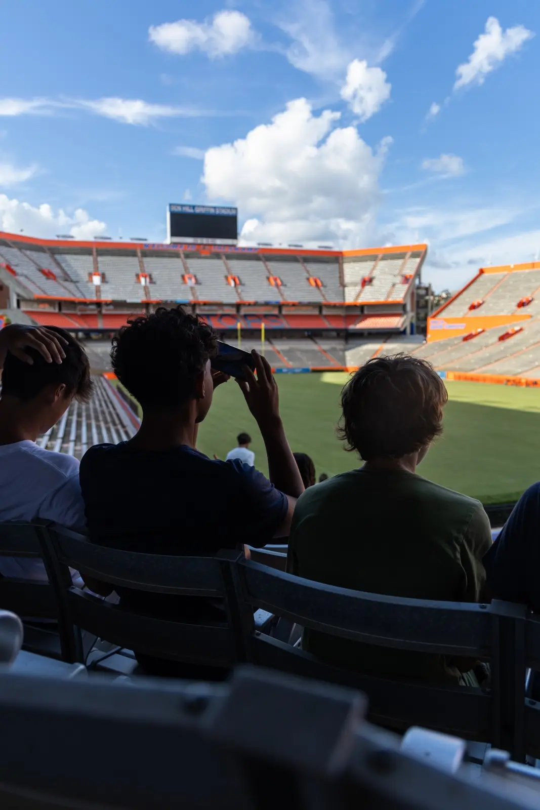 Campers in the stands looking out over the field at the UF football stadium
