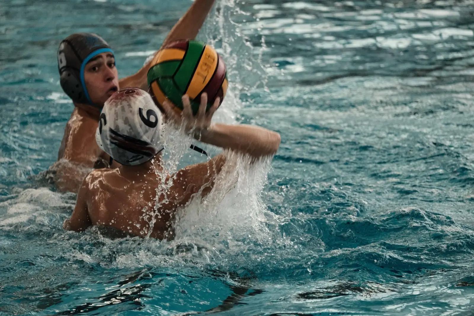 A player shielding the ball from a defender
