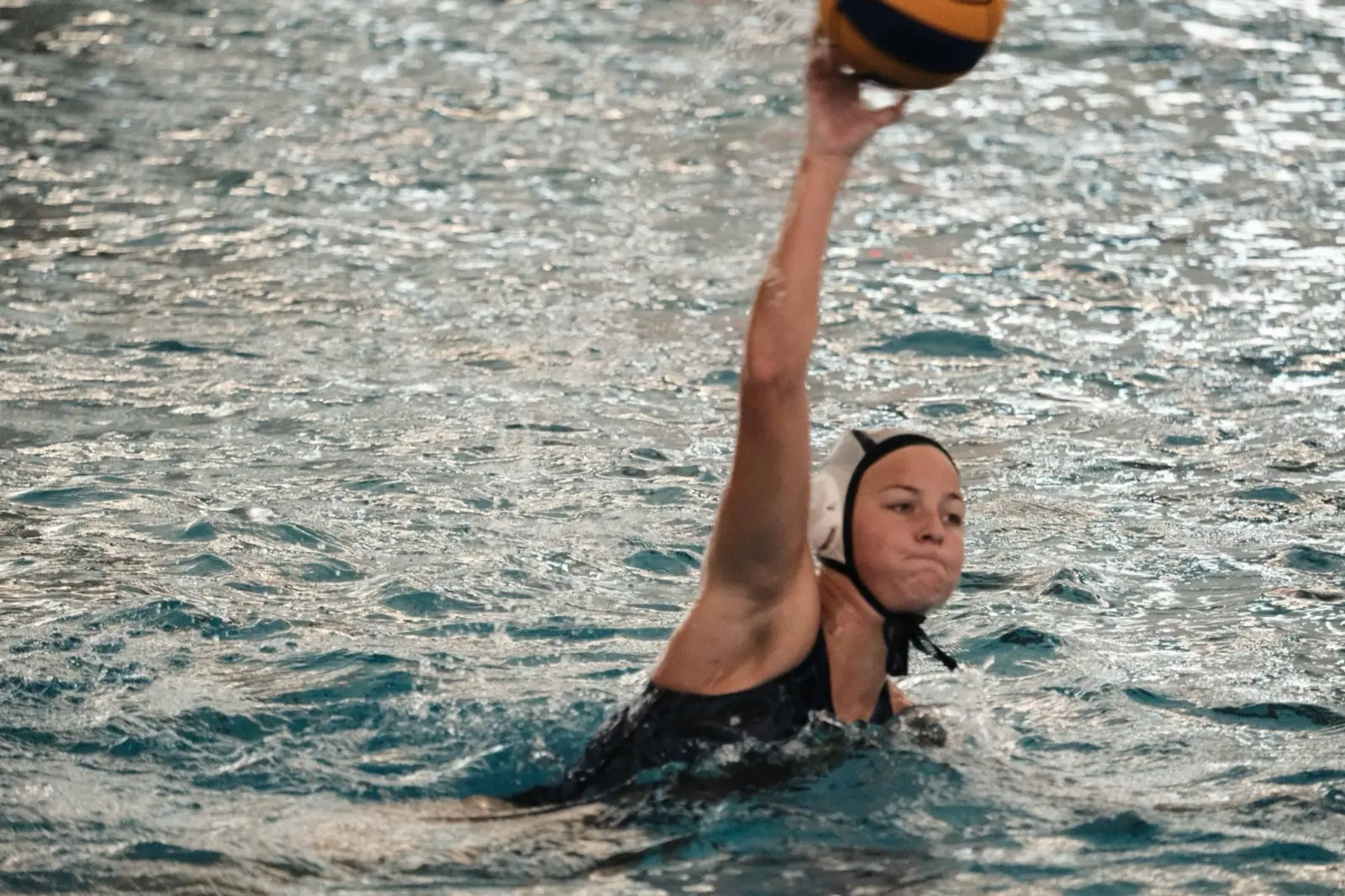 An athlete reaching high for a pass