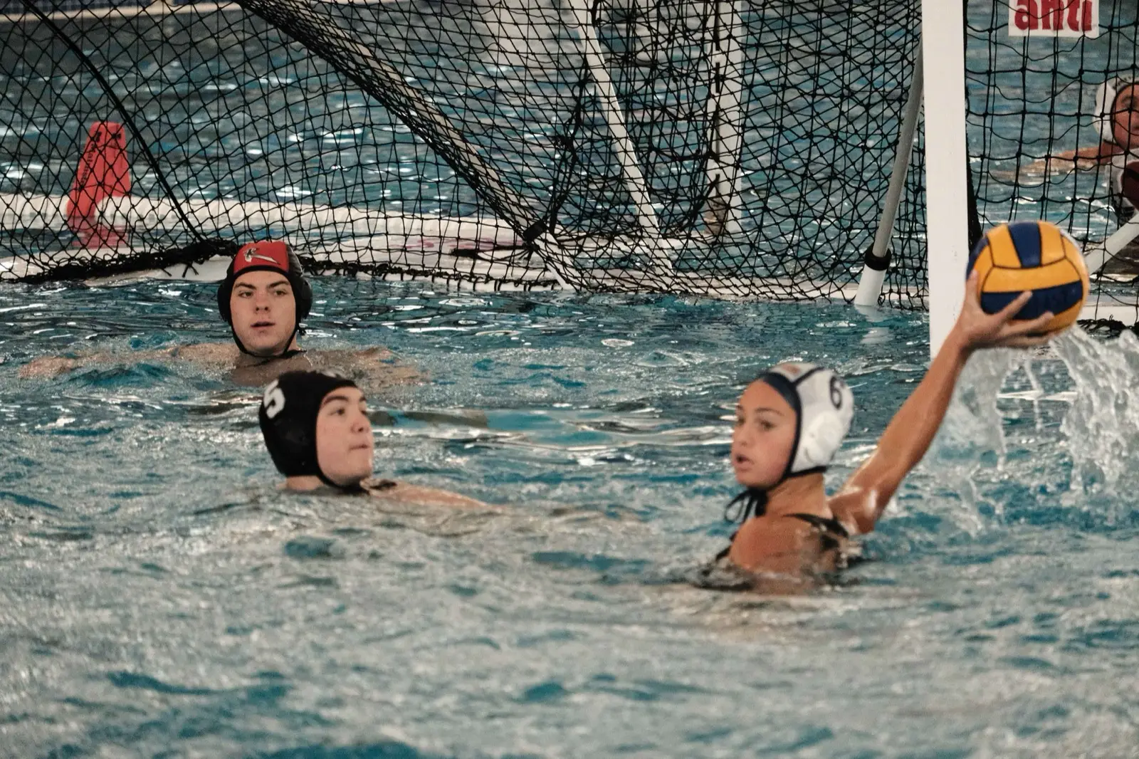 An athlete shooting from close in front of the cage