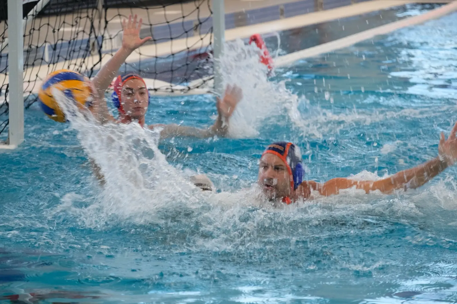 A goalkeeper throwing up spray to block a shot