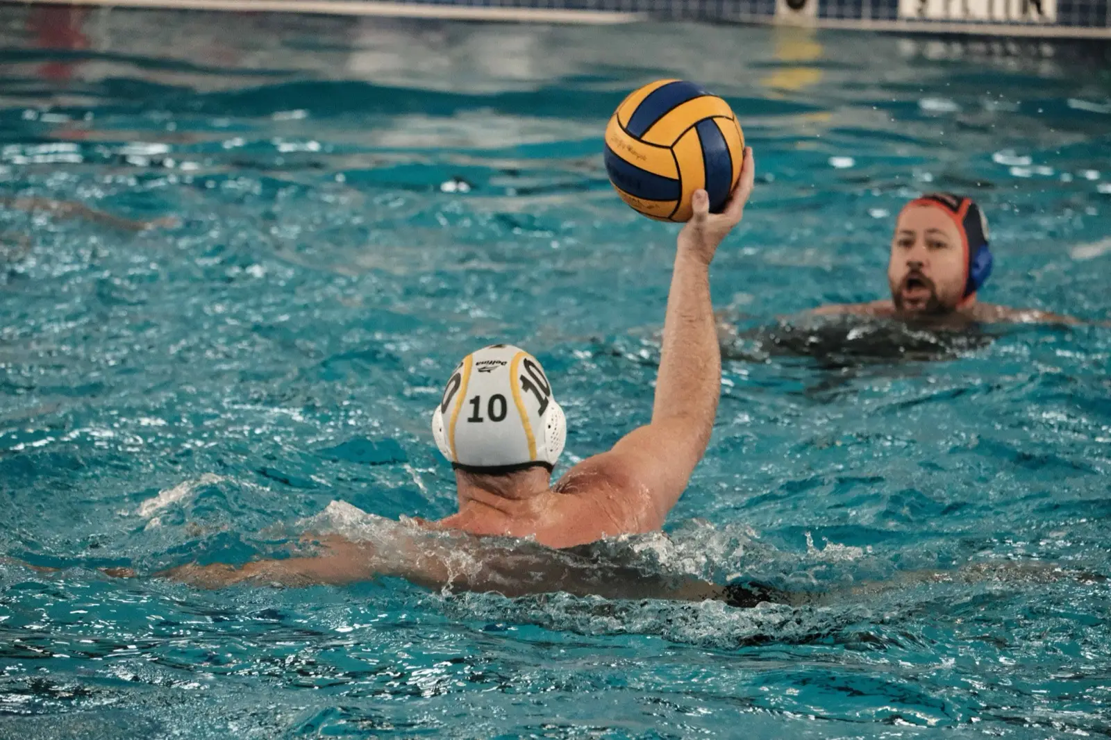 An adult player lifting the ball to shoot during a Masters game