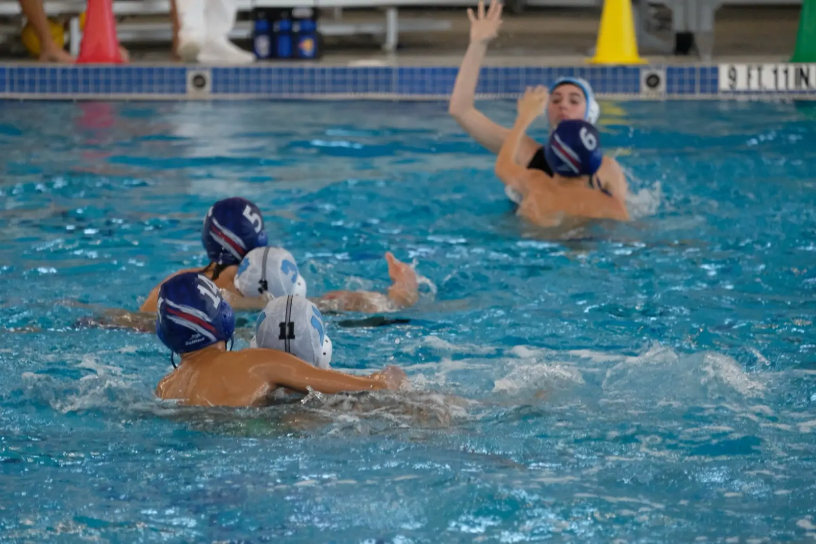 A young player driving toward goal with the ball