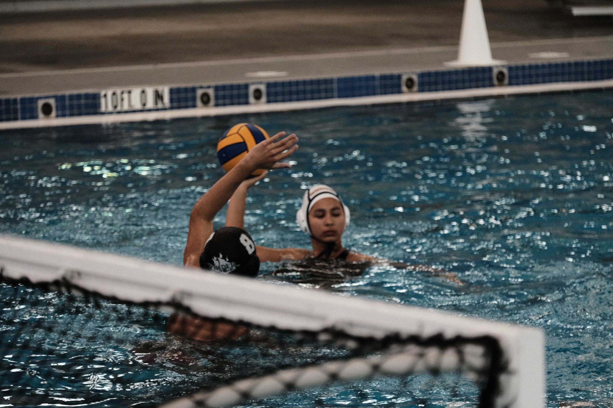 Two athletes contesting the ball