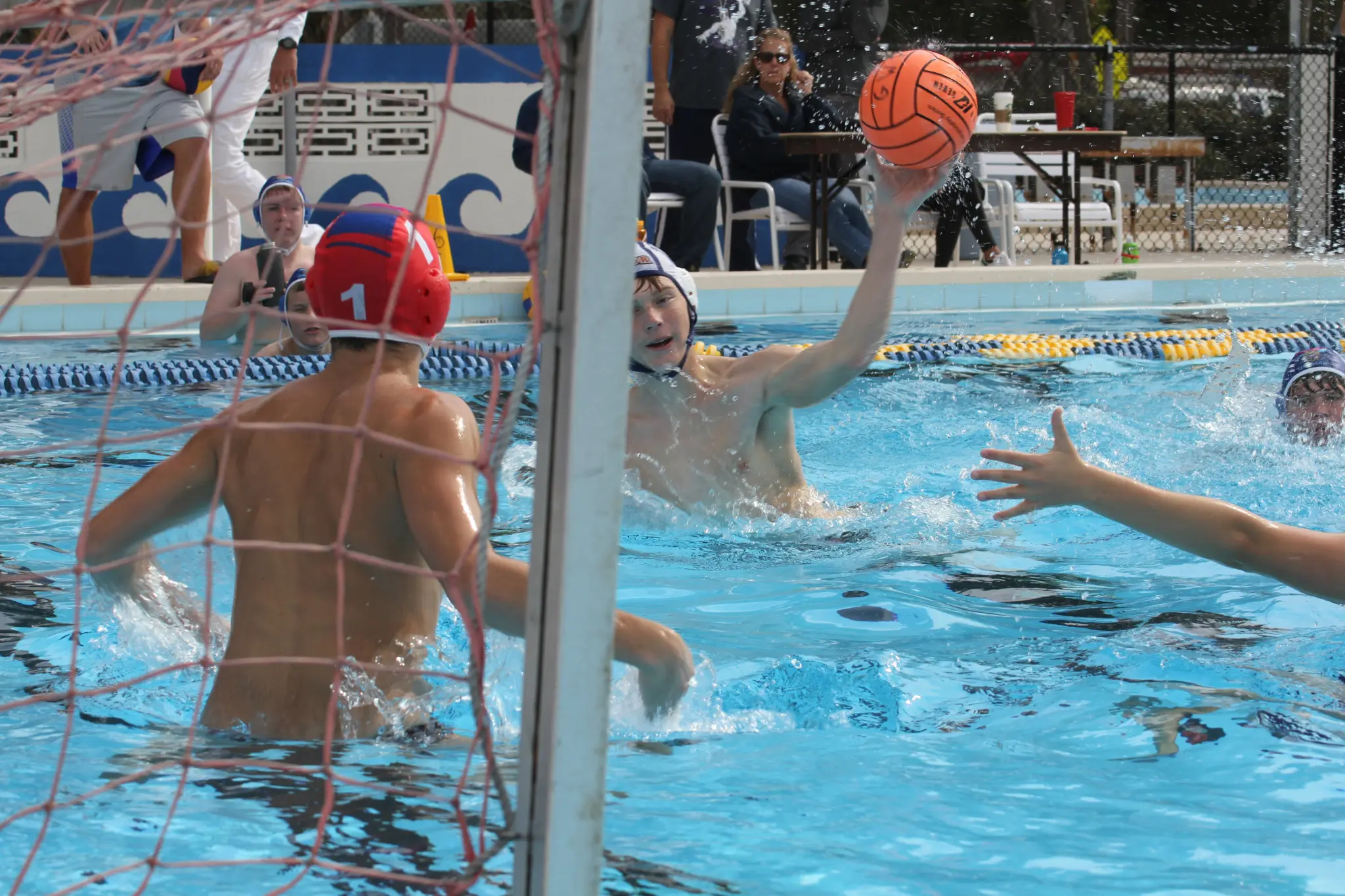 A Gator Water Polo athlete shooting on goal